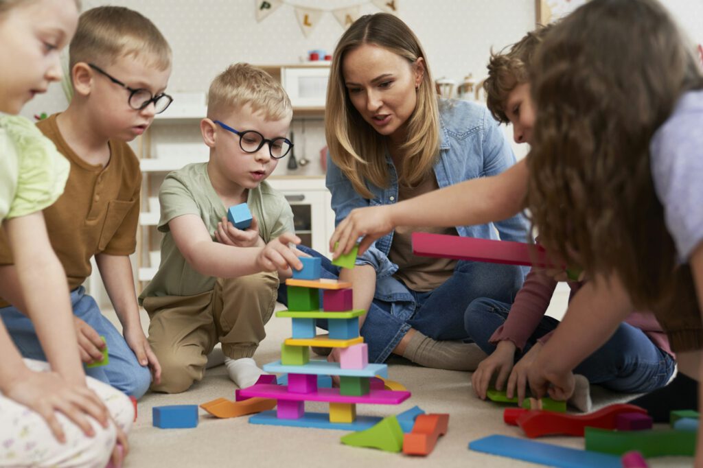 Children playing with toy blocks in the kindergarten