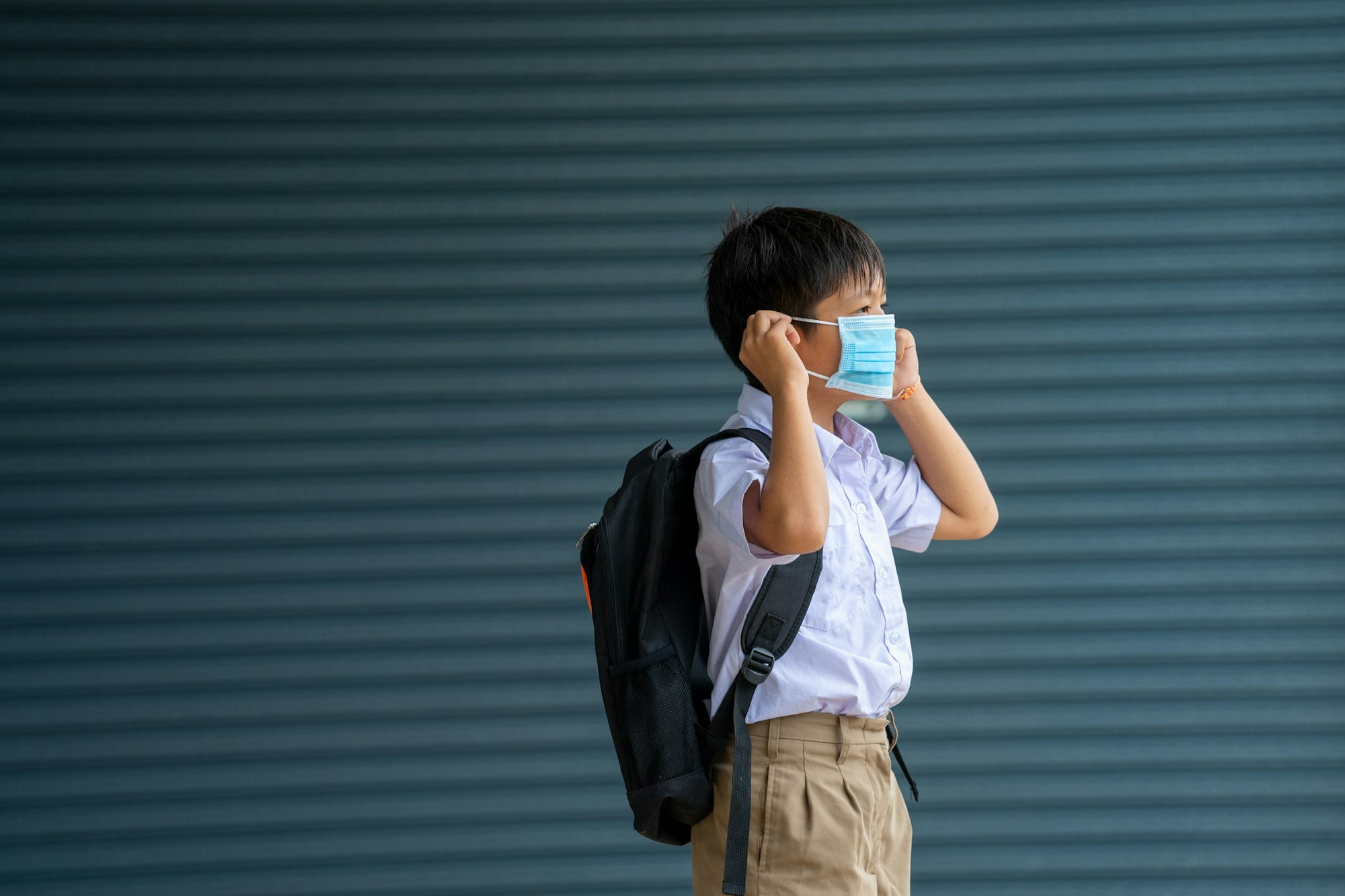 Elementary school students with face mask back at school after covid-19 quarantine and lockdown.